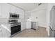 Modern kitchen with stainless steel appliances, white cabinets, and light countertops, offering a bright and functional cooking space at 4604 Hunts Ave, Plant City, FL 33566