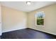 Bedroom with dark wood flooring, natural light, and neutral walls at 212 Citrus Landing Dr, Plant City, FL 33563