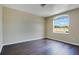 Bedroom with dark wood flooring, natural light, and neutral walls at 212 Citrus Landing Dr, Plant City, FL 33563