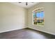 Bedroom featuring dark wood flooring, a large window, and neutral-colored walls at 212 Citrus Landing Dr, Plant City, FL 33563