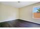 Bedroom with dark wood flooring, natural light, and neutral walls at 212 Citrus Landing Dr, Plant City, FL 33563