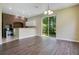 Dining area with sliding doors, adjacent to a bar and brick-accented kitchen at 212 Citrus Landing Dr, Plant City, FL 33563