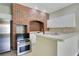 Modern kitchen with stainless steel appliances, bar seating and unique brick design at 212 Citrus Landing Dr, Plant City, FL 33563