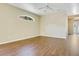 Light-filled living area with wood flooring, arch window, and neutral walls at 212 Citrus Landing Dr, Plant City, FL 33563
