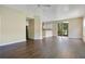 Open-concept living space with wood floors, bar area, and sliding doors to the backyard at 212 Citrus Landing Dr, Plant City, FL 33563