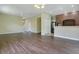 Large living area with a staircase, pantry doors, and a brick-accented kitchen at 212 Citrus Landing Dr, Plant City, FL 33563