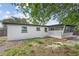 Spacious backyard featuring a screened-in porch and stone accents at 4119 Beacon Square Dr, Holiday, FL 34691