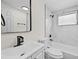 The remodeled bathroom features new marble tile, a modern sink, and a new tub at 4119 Beacon Square Dr, Holiday, FL 34691