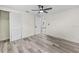 Light bedroom with closet, new ceiling fan and freshly painted white walls and new wood-look floors at 4119 Beacon Square Dr, Holiday, FL 34691