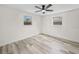 Bright bedroom featuring a new ceiling fan and light-filled windows at 4119 Beacon Square Dr, Holiday, FL 34691