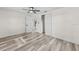Clean bedroom showcases a new ceiling fan, white walls, and light wood-look floors at 4119 Beacon Square Dr, Holiday, FL 34691