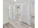 Bright hallway featuring wood-look floors and white doors, creating a clean and modern feel at 4119 Beacon Square Dr, Holiday, FL 34691