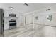 Modern kitchen featuring stainless steel appliances, white cabinets, and new countertops at 4119 Beacon Square Dr, Holiday, FL 34691