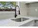 Close-up of the sink area featuring quartz countertops and modern faucet at 4119 Beacon Square Dr, Holiday, FL 34691