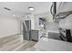 Contemporary kitchen featuring stainless steel appliances and access to the screened patio at 4119 Beacon Square Dr, Holiday, FL 34691