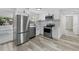 Modern kitchen featuring stainless steel appliances, white cabinets, and quartz countertops at 4119 Beacon Square Dr, Holiday, FL 34691