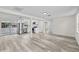 Bright, open-concept living space with modern flooring and stainless steel appliances at 4119 Beacon Square Dr, Holiday, FL 34691