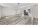 Bright, open-concept living space with modern flooring and stainless steel appliances at 4119 Beacon Square Dr, Holiday, FL 34691