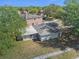 Aerial view of a home's backyard, with a screened in porch and well kept lawn at 4601 Copper Ln, Plant City, FL 33566
