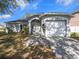 Charming one-story home featuring a manicured lawn, arched entry, and two-car garage at 4601 Copper Ln, Plant City, FL 33566