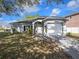 Single-story home featuring a manicured lawn and attached two-car garage at 4601 Copper Ln, Plant City, FL 33566