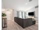 Bright living room with a sectional sofa, entryway with an arched window, and wood-look flooring at 4601 Copper Ln, Plant City, FL 33566