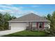 Charming single-story home featuring a well-maintained lawn, two-car garage, and a classic roof design at 6328 Scarlet Amethyst St, Land O Lakes, FL 34638