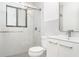 Bright bathroom featuring a glass-enclosed shower, tile, and white vanity at 2239 Worrington St, Sarasota, FL 34231