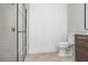 Modern bathroom with neutral tile, glass enclosed shower, and a wood-look vanity at 2239 Worrington St, Sarasota, FL 34231