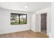 Bright bedroom with a large window and wood floors, leading into the bathroom at 2239 Worrington St, Sarasota, FL 34231