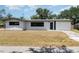 Inviting single-story home with a driveway, well-maintained lawn, and a bright, sunny sky at 2239 Worrington St, Sarasota, FL 34231