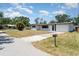 Inviting single-story home showcasing a driveway, mailbox, and a well-maintained lawn under a bright sky at 2239 Worrington St, Sarasota, FL 34231