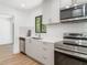Modern kitchen featuring stainless steel appliances, subway tile backsplash, and ample cabinet space at 2239 Worrington St, Sarasota, FL 34231