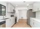 Modern kitchen featuring stainless steel appliances, subway tile backsplash, and wood-look flooring at 2239 Worrington St, Sarasota, FL 34231