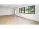 Bright living room with wood-look flooring, large windows, and neutral walls at 2239 Worrington St, Sarasota, FL 34231