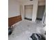 Bedroom featuring bare concrete floor, open closet and access to other rooms at 3607 Johnson Ct, Palm Harbor, FL 34684