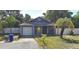 Charming single-story home featuring a classic gable roof and a cozy front porch bench at 3607 Johnson Ct, Palm Harbor, FL 34684