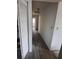 Hallway featuring wood-look flooring, white walls and access to other rooms at 3607 Johnson Ct, Palm Harbor, FL 34684
