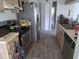 A kitchen featuring wood laminate floors, stainless steel appliances, and plenty of cabinet space at 3607 Johnson Ct, Palm Harbor, FL 34684