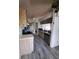Kitchen with wood-look tile flooring and cabinets featuring a full appliance package at 3607 Johnson Ct, Palm Harbor, FL 34684