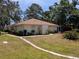 Lovely single-story home with a well-maintained lawn, mature trees, and decorative landscaping at 5356 Royal Palm Ave # 5356, Sarasota, FL 34234