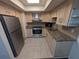 Kitchen with stainless steel appliances, granite countertops, and light wood cabinets at 5356 Royal Palm Ave # 5356, Sarasota, FL 34234