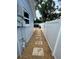 Side view of backyard with above ground pool and stepping stone walkway between fences at 9153 86Th Ave, Seminole, FL 33777