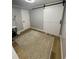 Bright bedroom with a sliding barn door features a decorative rug on the hardwood floor at 9153 86Th Ave, Seminole, FL 33777