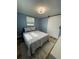 Comfortable bedroom features a barn door and a decorative rug on the hardwood floor at 9153 86Th Ave, Seminole, FL 33777
