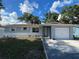 Charming single-story home featuring a manicured lawn, fresh landscaping, and a one car garage at 9153 86Th Ave, Seminole, FL 33777