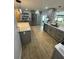 Bright kitchen featuring quartz countertops, stainless steel appliances, and grey cabinets for a modern look at 9153 86Th Ave, Seminole, FL 33777