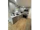 The remodeled kitchen features gray cabinets, modern appliances, and quartz countertops at 9153 86Th Ave, Seminole, FL 33777