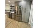 Stainless steel appliances, quartz counters, and gray cabinets provide a modern touch to this kitchen at 9153 86Th Ave, Seminole, FL 33777