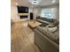 Comfortable living room with a large sectional sofa, fireplace, and natural light from the window at 9153 86Th Ave, Seminole, FL 33777